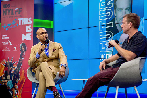 Jack Rico speaking on stage at a media event